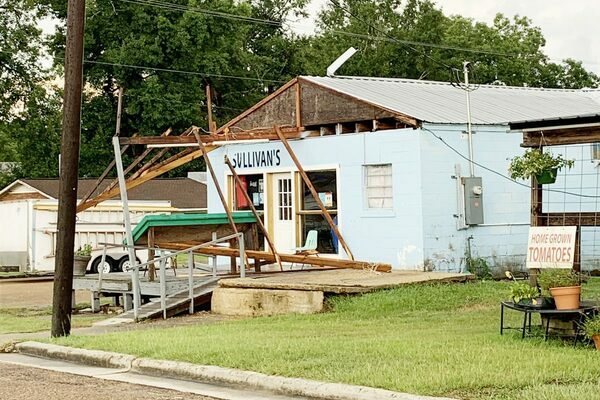 Straight-line winds from a Wednesday afternoon thunderstorm ripped the front porch from Sullivan's Kitchen and Produce at the corner of Second and Walnut streets in Meadville. (Photo by Sean Dunlap)